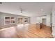 Open floor plan with kitchen island, stainless appliances, recessed lights, wood flooring, and sliding glass doors at 7444 Malabar Rd # 14, Huntersville, NC 28078