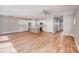 Open floor plan with white kitchen, wood flooring, modern lighting, and neutral paint at 7444 Malabar Rd # 14, Huntersville, NC 28078