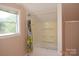 Cozy bathroom featuring a tub, window, and unique curtain at 7780 Stokes Ferry Rd, Salisbury, NC 28146