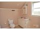 Charming bathroom with sink, toilet, vanity and window at 7780 Stokes Ferry Rd, Salisbury, NC 28146
