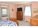 Comfortable bedroom with neutral walls, natural light, and classic wooden furniture at 7780 Stokes Ferry Rd, Salisbury, NC 28146