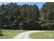 Long, private driveway leading through a forest to a secluded property, providing ultimate privacy at 7780 Stokes Ferry Rd, Salisbury, NC 28146
