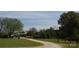 Sprawling property featuring a winding gravel driveway and lush greenery, showcasing natural beauty at 7780 Stokes Ferry Rd, Salisbury, NC 28146