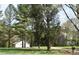 Charming exterior view with a long driveway and mature trees providing privacy at 7780 Stokes Ferry Rd, Salisbury, NC 28146