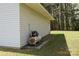 Exterior corner of a white garage with a vintage air compressor sitting outside at 7780 Stokes Ferry Rd, Salisbury, NC 28146