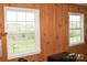 Wood-paneled room showcases a view through two windows of a beautiful yard with trees at 7780 Stokes Ferry Rd, Salisbury, NC 28146