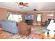 Spacious living room features a large TV, comfortable seating, and bright, colorful rug at 7780 Stokes Ferry Rd, Salisbury, NC 28146