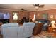 Cozy living room with plush seating, colorful rug, and ceiling fans for added comfort at 7780 Stokes Ferry Rd, Salisbury, NC 28146
