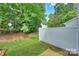 Serene backyard with a privacy fence and mature trees, offering a peaceful retreat at 8453 Big Creek Ct, Charlotte, NC 28105