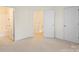View of the carpeted bedroom leading to the bathroom, stairs, and bedroom entrance at 8453 Big Creek Ct, Charlotte, NC 28105