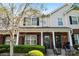 Attractive townhomes with brick and siding exteriors, complemented by black shutters and manicured shrubbery at 8453 Big Creek Ct, Charlotte, NC 28105