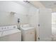 Laundry room with a washer and dryer adjacent to a white door at 8453 Big Creek Ct, Charlotte, NC 28105