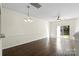Spacious, naturally lit living room with hardwood floors and access to the outdoors through sliding doors at 8453 Big Creek Ct, Charlotte, NC 28105