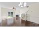 Bright, open living room featuring hardwood floors, a fireplace, and sliding glass doors to the backyard at 8453 Big Creek Ct, Charlotte, NC 28105