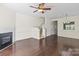 Bright living room with hardwood floors, fireplace, stairs to the second floor, and view of the adjacent dining area at 8453 Big Creek Ct, Charlotte, NC 28105