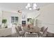 Cozy living room with fireplace, hardwood floors, and an adjacent dining area with sliding glass doors to the patio at 8453 Big Creek Ct, Charlotte, NC 28105