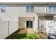 Rear patio with a sliding glass door and a small grassy yard and white fencing at 8453 Big Creek Ct, Charlotte, NC 28105