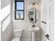 Charming powder room with a pedestal sink, modern lighting, and a window for natural light at 8707 Nolley Ct, Charlotte, NC 28270