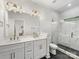 Beautiful bathroom features double sinks, quartz counters, and large glass enclosed shower at 8707 Nolley Ct, Charlotte, NC 28270