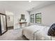 Bright bedroom featuring neutral walls, carpet, and entry to bath with double vanity at 8707 Nolley Ct, Charlotte, NC 28270