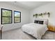 Sunlit bedroom with hardwood floors, modern decor, and picturesque window view at 8707 Nolley Ct, Charlotte, NC 28270
