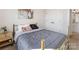 Comfortable bedroom featuring a gold metal frame bed, a natural wood nightstand and closet at 8707 Nolley Ct, Charlotte, NC 28270