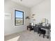 Well-lit bedroom with a vanity table, decor and a large window showcasing city views at 8707 Nolley Ct, Charlotte, NC 28270