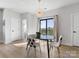 Modern dining area with stylish chairs, a black oval table, contemporary light fixture, and sliding door to balcony at 8707 Nolley Ct, Charlotte, NC 28270
