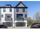 Modern townhome showcasing a two-car garage, clean lines and a symmetric façade with a small balcony at 8707 Nolley Ct, Charlotte, NC 28270
