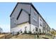 Modern townhome with vertical siding, contrasted by a manicured lawn and landscaped planting bed at 8707 Nolley Ct, Charlotte, NC 28270