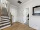 Bright foyer with hardwood floors, stairs with wood handrail, and white trimwork throughout at 8707 Nolley Ct, Charlotte, NC 28270