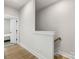 Open hallway leading to bedrooms features wood floors and white walls at 8707 Nolley Ct, Charlotte, NC 28270