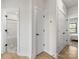 Hallway featuring a view of the bathroom and bedroom, with bright white walls at 8707 Nolley Ct, Charlotte, NC 28270