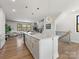 Open-concept kitchen features a large center island with quartz countertop and gold pendant lighting at 8707 Nolley Ct, Charlotte, NC 28270