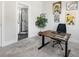 Bright home office featuring neutral carpet, a desk with artwork, and an ensuite bath with glass shower at 8707 Nolley Ct, Charlotte, NC 28270