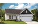 Charming single-story home featuring a stone-accented facade, a two-car garage, and a well-manicured lawn at 1026 Mapletree Ln, Indian Trail, NC 28079