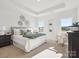 Serene main bedroom featuring tray ceiling, carpet, neutral decor, and plenty of natural light at 1026 Mapletree Ln, Indian Trail, NC 28079