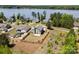 Beautiful waterfront home with manicured lawn near a lake, complemented by lovely landscaping and lake views at 10270 Lakeshore Dr, Lancaster, SC 29720