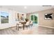 Open dining room with a sliding glass door, modern art, and seating for four at 1036 Hostler Ln, York, SC 29745