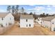 Backyard view of a two-story home with privacy fence and partially seeded lawn at 111 Buoy Ln # 392, Statesville, NC 28677