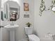 Bathroom with pedestal sink, decorative mirror, and art pieces at 111 Buoy Ln # 392, Statesville, NC 28677