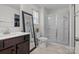 Bright bathroom featuring a glass shower, large mirror, vanity sink and tiled floors at 111 Buoy Ln # 392, Statesville, NC 28677