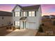 Beautiful home with a two-car garage, welcoming entrance and freshly landscaped lawn at 111 Buoy Ln # 392, Statesville, NC 28677