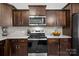 Well-equipped kitchen features stainless steel appliances, granite countertops, and dark wood cabinetry at 111 Buoy Ln # 392, Statesville, NC 28677