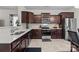 Modern kitchen equipped with stainless steel appliances, wooden cabinets, and elegant countertops at 111 Buoy Ln # 392, Statesville, NC 28677
