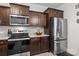 Features stainless steel fridge, microwave, stove, dark cabinetry, and granite countertops at 111 Buoy Ln # 392, Statesville, NC 28677