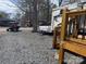 RV exterior with golf cart in RV community with gravel at 120 Cherokee Trl, Mount Gilead, NC 27306
