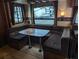 Dinette area featuring comfortable booth seating, table, and large windows at 120 Cherokee Trl, Mount Gilead, NC 27306