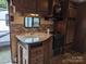 Well-equipped kitchen featuring a modern sink, tile backsplash, gas range and dark cabinets at 120 Cherokee Trl, Mount Gilead, NC 27306