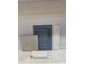 Close-up of a blue kitchen cabinet door, quartz countertop and backsplash samples at 13408 Chopin Ridge Rd, Huntersville, NC 28078